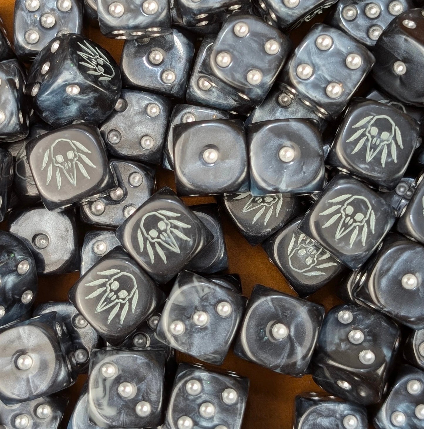 Pile of black raven skull 16mm D6 dice ready for a fantasy carrion army