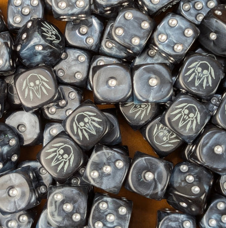 Pile of black raven skull 16mm D6 dice ready for a fantasy carrion army