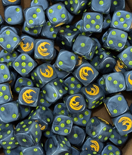 Pile of black 16mm D6 dice with yellow moon emblems for a fantasy goblin army
