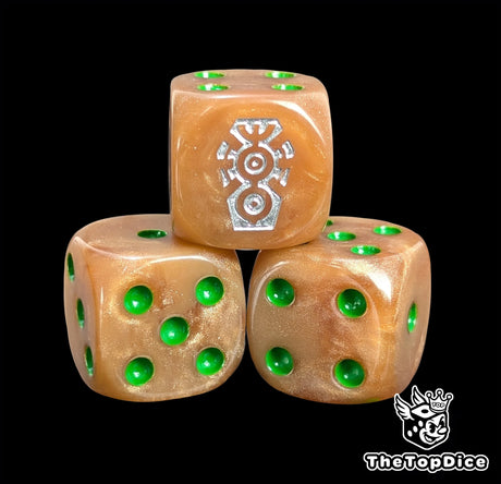 Close up of a copper 16mm resin D6 die engraved with a silver rune and green pips