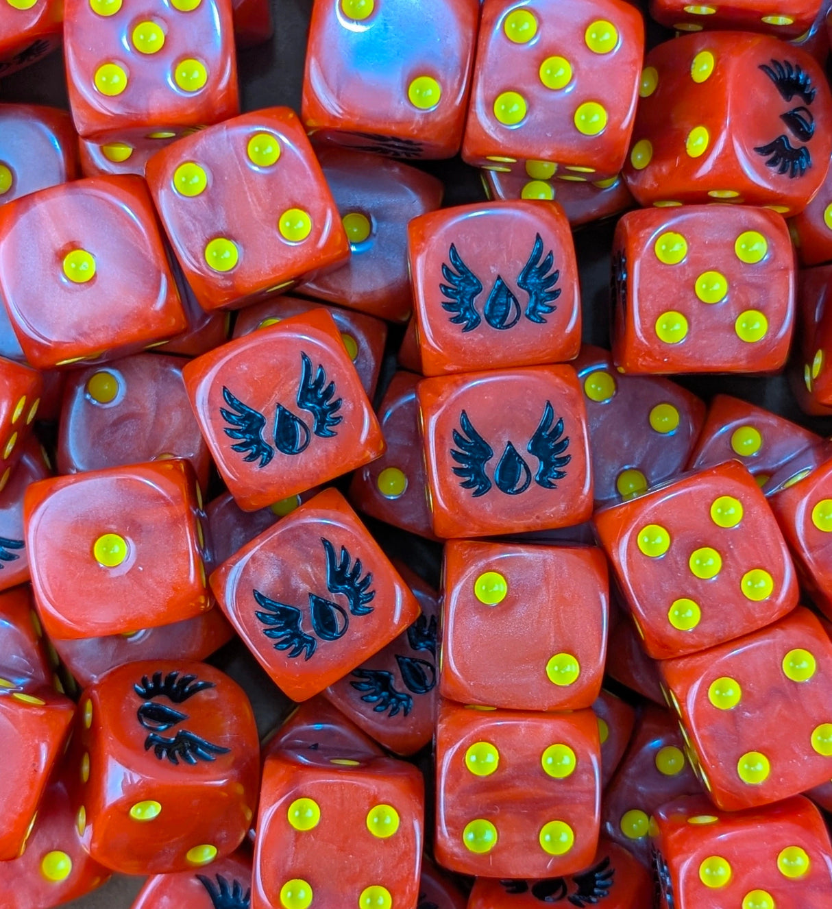 Pile of blood red winged drop 16mm D6 dice for a sci-fi marine army