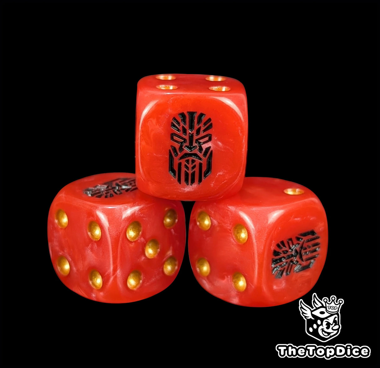 Close up of a red 16mm resin D6 die engraved with a black rune and a stern face