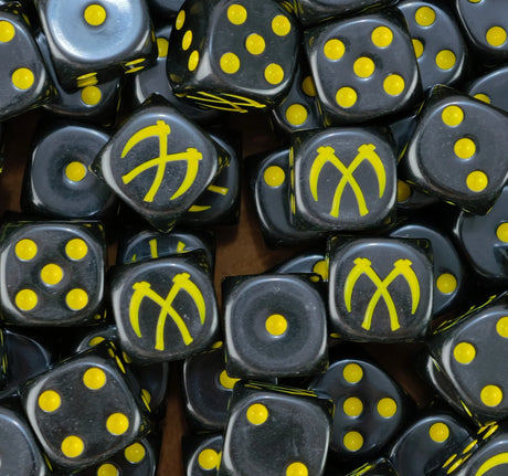 A pile of black Scythes of the Emperor dice, yellow crossed scythes and yellow pips repeating