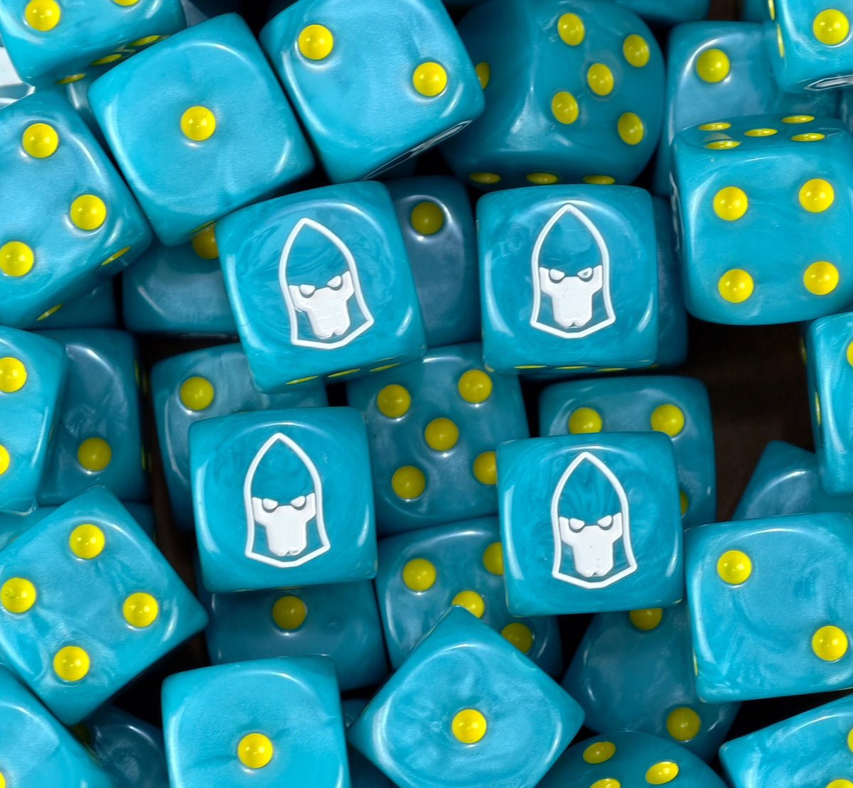 A pile of cyan Swooping Hawks dice with white helms and yellow pips