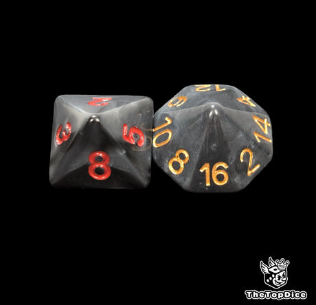 Close up of a black D8 and D16 with gold numbers for scatter and long range rolls