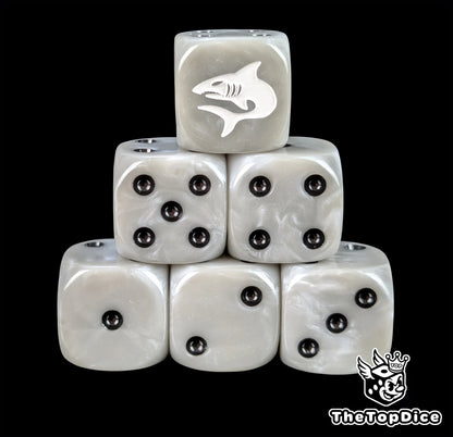 Grey resin D6 dice with a white shark emblem and black pips