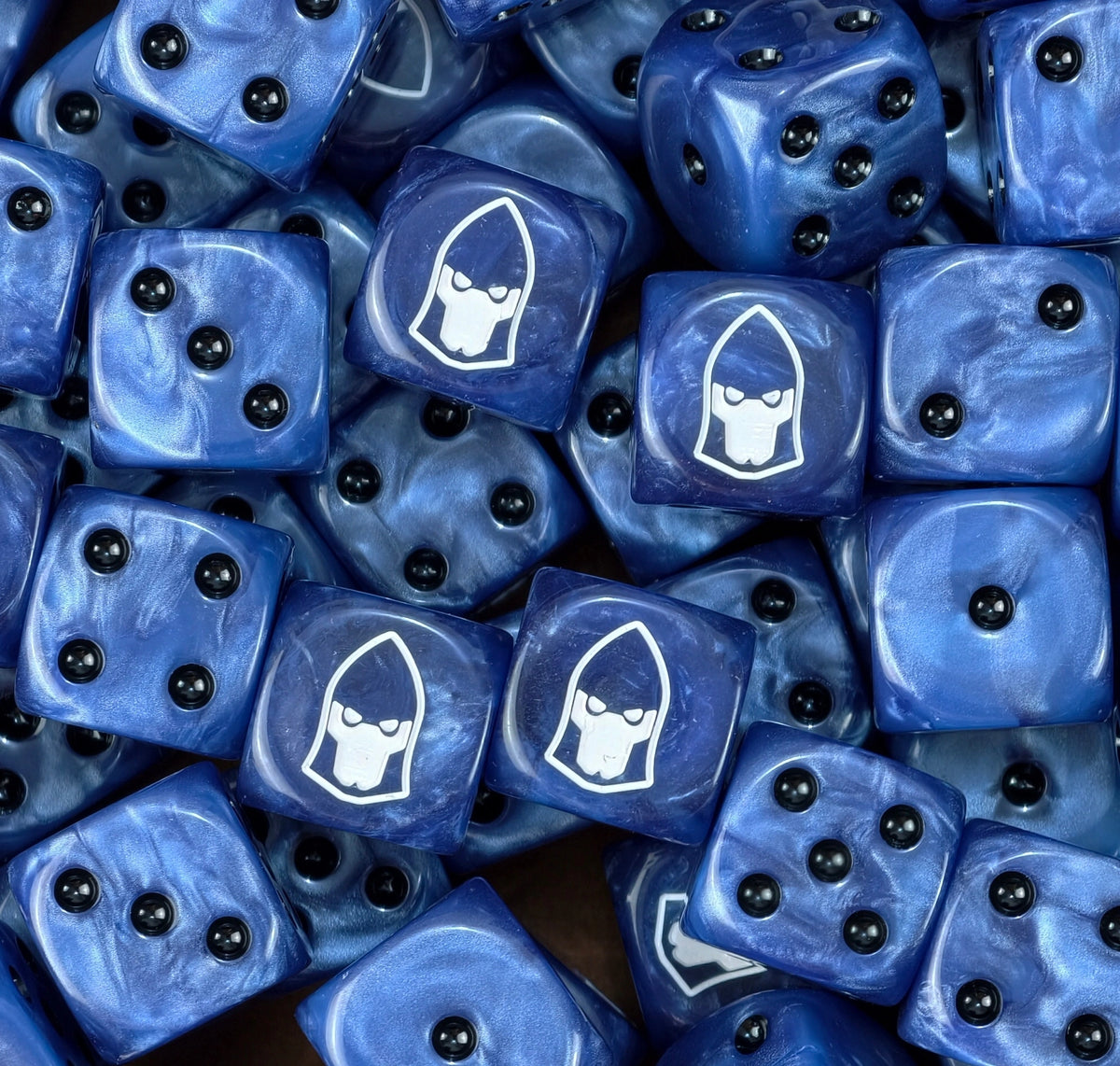 Pile of blue Dire Avengers eldar dice showing black pips and the white helm face