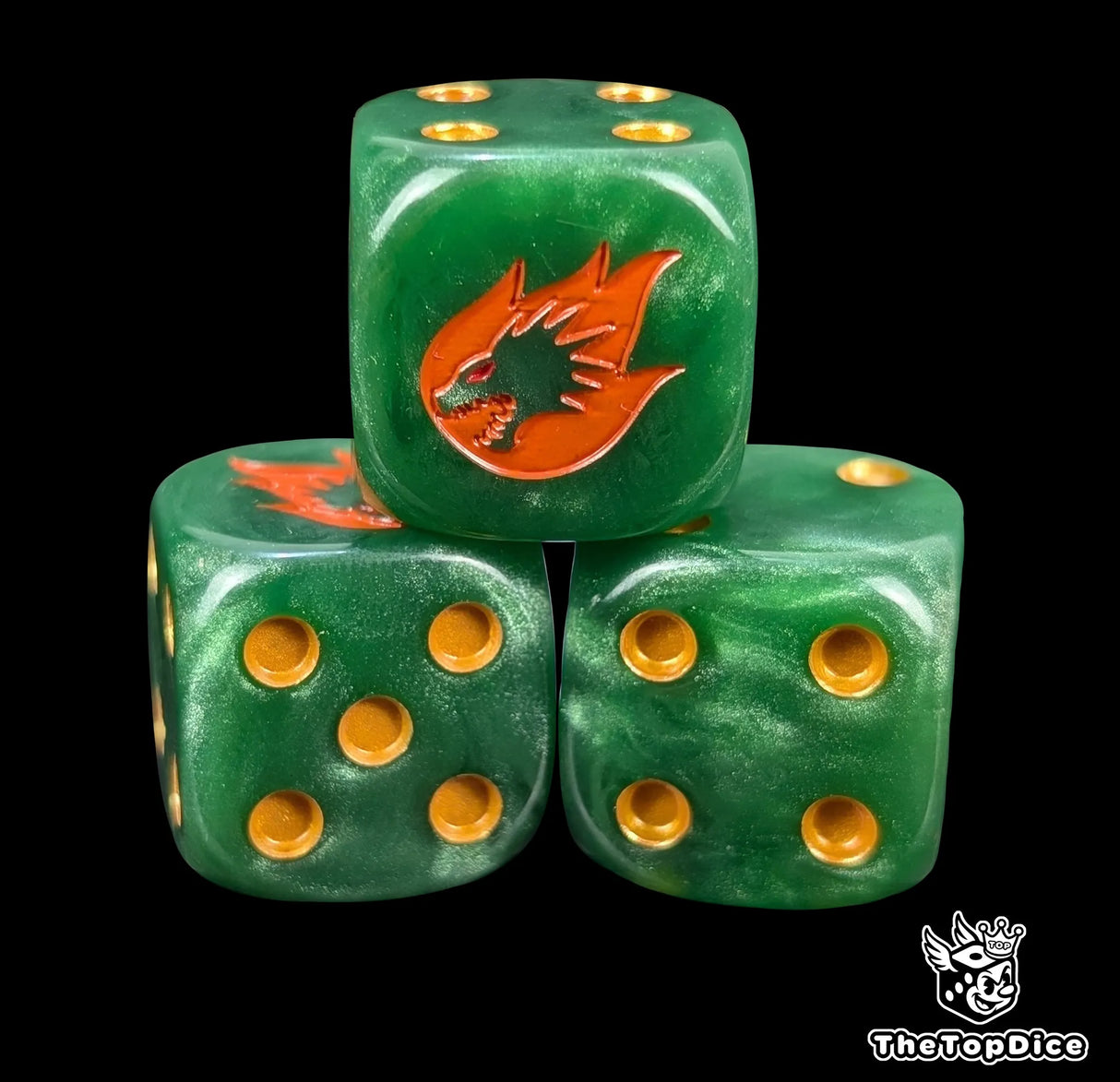 Close up of a green 16mm resin D6 die engraved with a gold drake head wreathed in orange fire