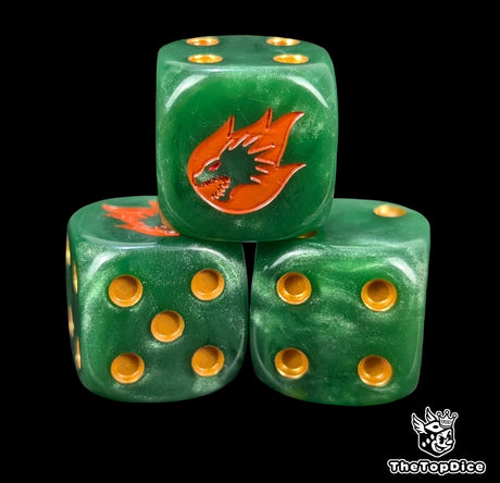 Close up of a green 16mm resin D6 die engraved with a gold drake head wreathed in orange fire