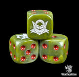 Close up of a green 16mm resin D6 die engraved with a white goblin silhouette and red pips
