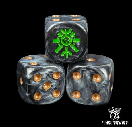 Close-up of three black and grey 16mm grimdark D6 dice engraved with a green tomb rune emblem