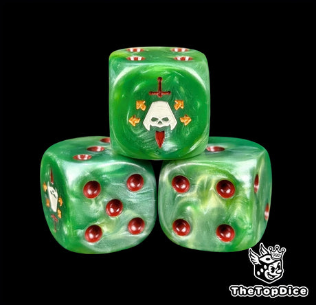 Close up of a green 16mm resin D6 die engraved with a face pierced by a red blade and gold stars