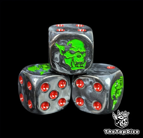 Close-up of a black D6 die with a snarling orc face