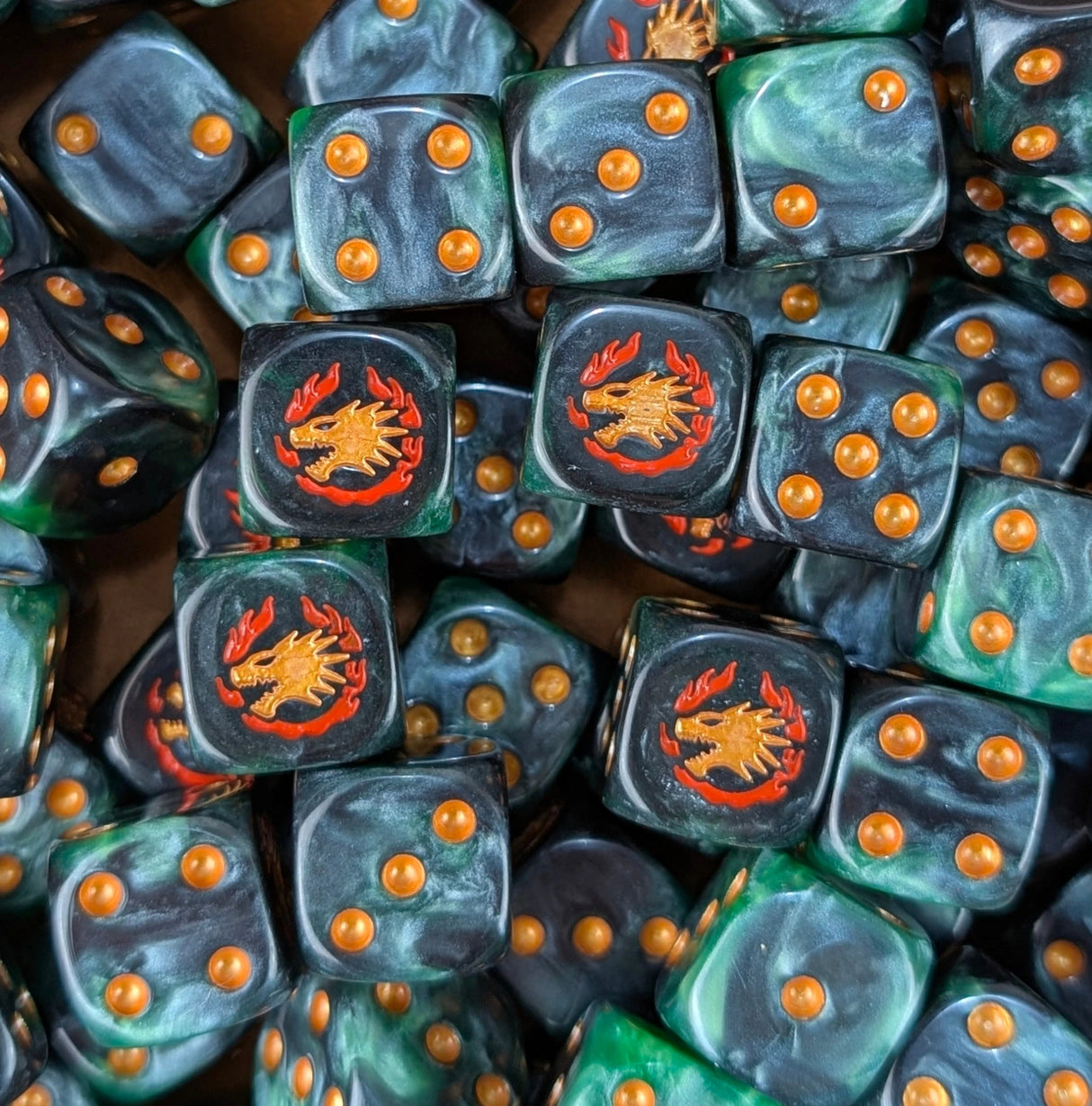 Pile of black and green fire drake 16mm D6 dice for a sci-fi knight army