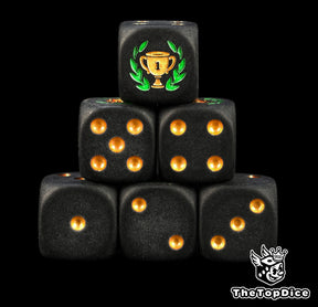 First place trophy dice, matte black 16mm D6 with gold pips and a gold winner's cup in a big green laurel, a tournament prize for board games and game nights