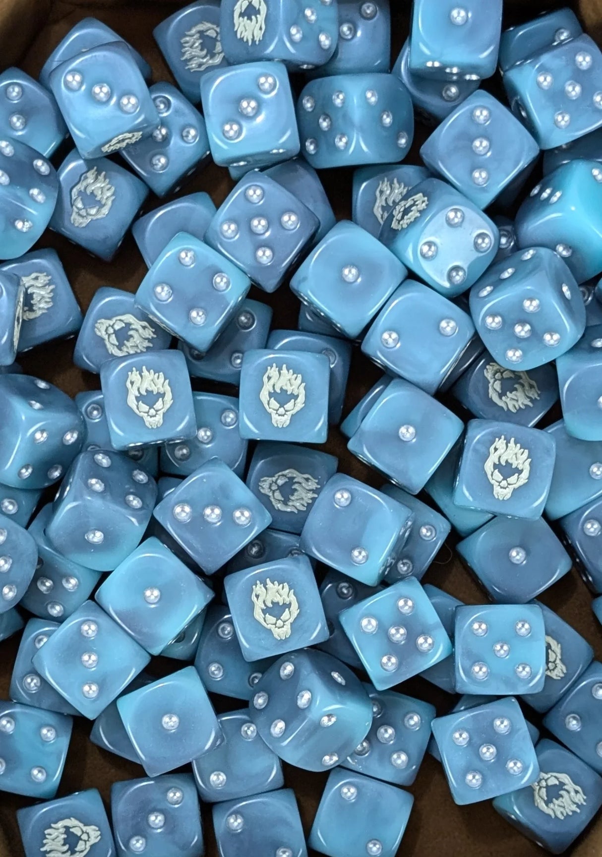 Pile of spectral blue ghost 16mm D6 dice for a fantasy undead army