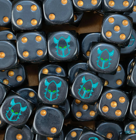 A pile of black Drukhari dice with gold pips and turquoise helms