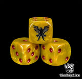 Close up of a gold 16mm resin D6 die engraved with a black eagle and red pips