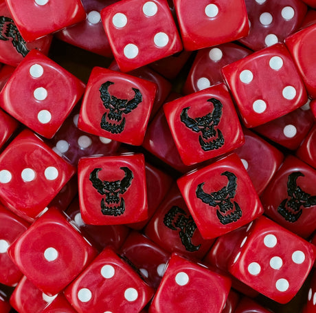 Pile of red Goff Orks dice with white pips and black tusked ork skulls
