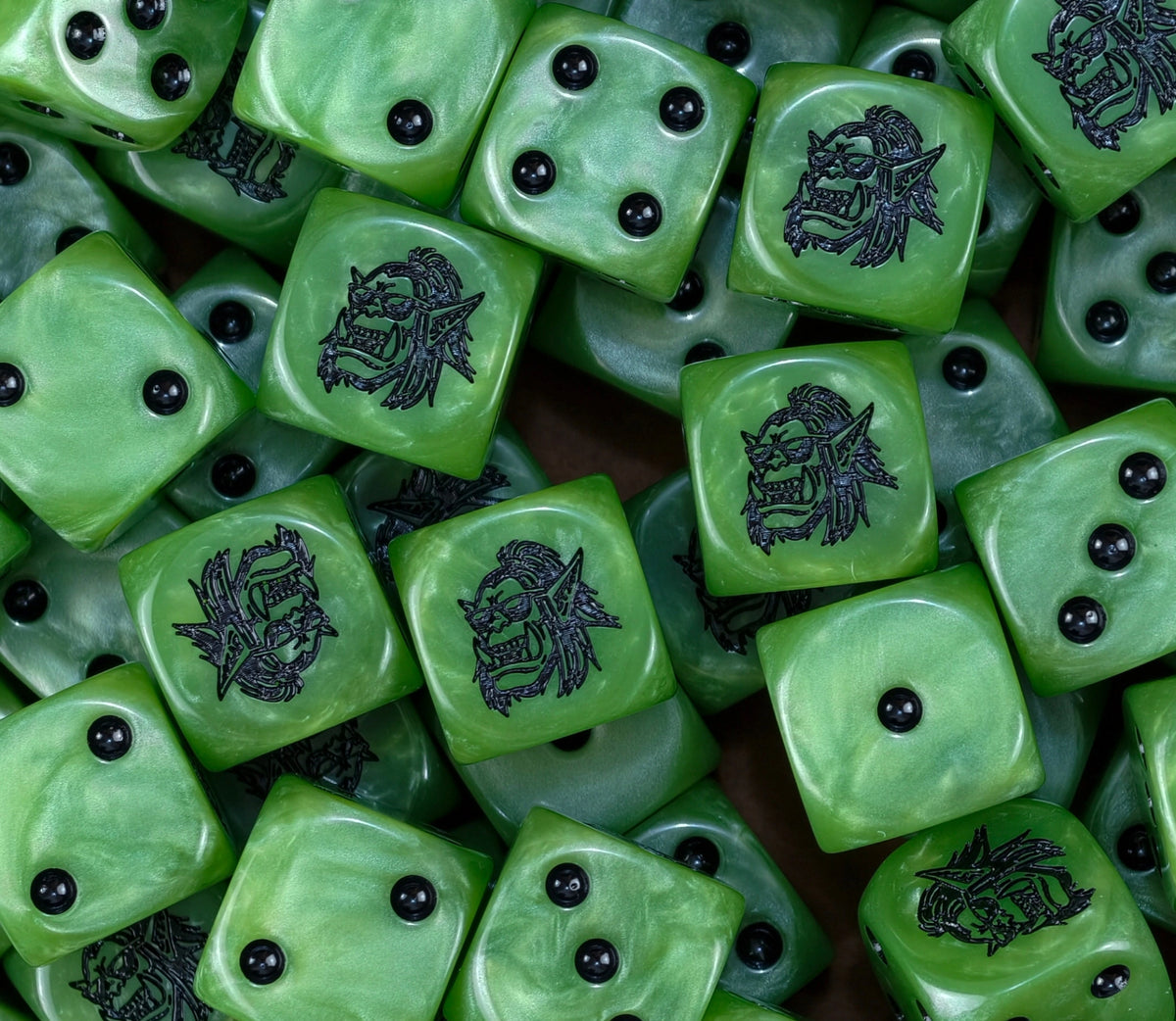 A pile of green orc D6 with black pips and goggled orc faces