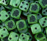 A pile of green orc D6 with black pips and goggled orc faces