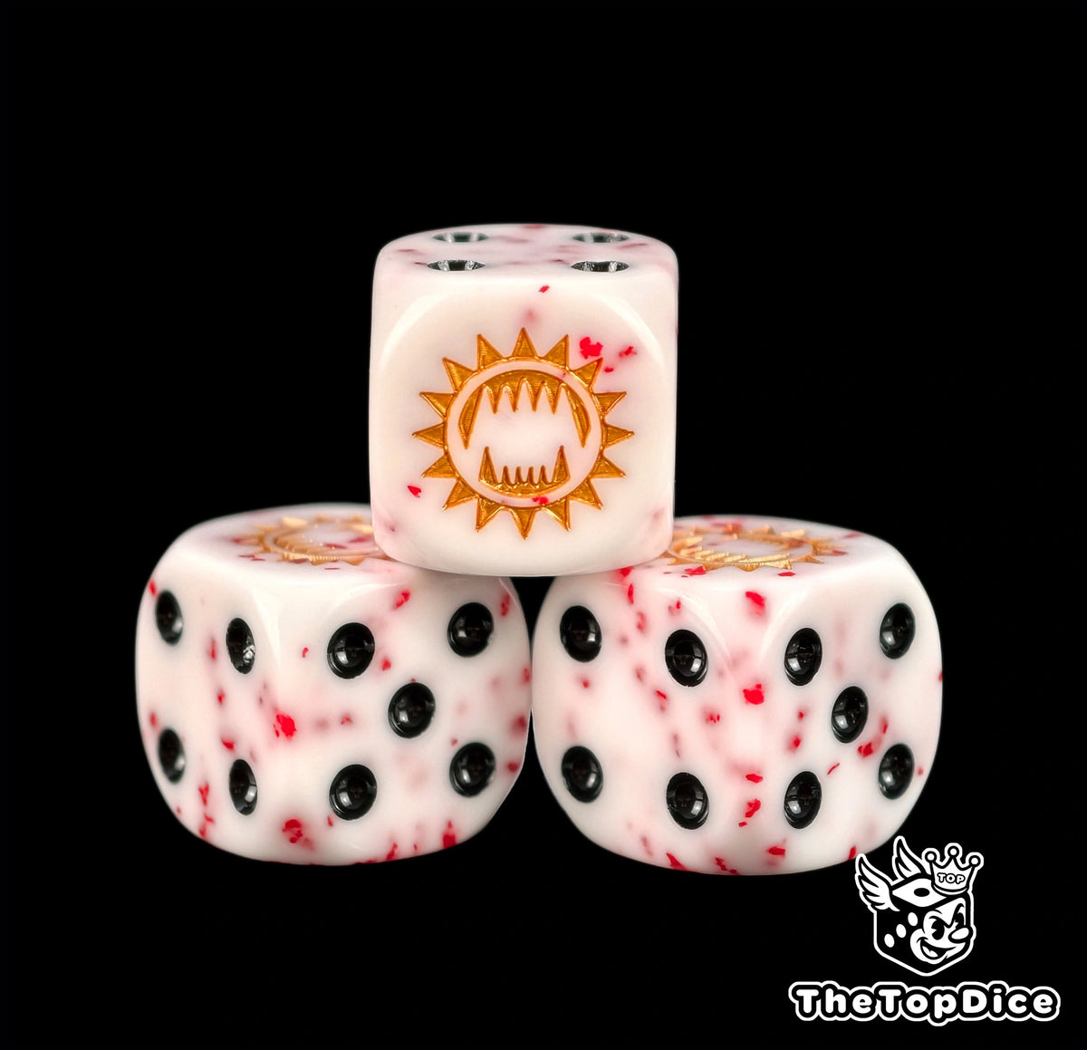 Three white Khorne dice flecked with red and a gold maw emblem