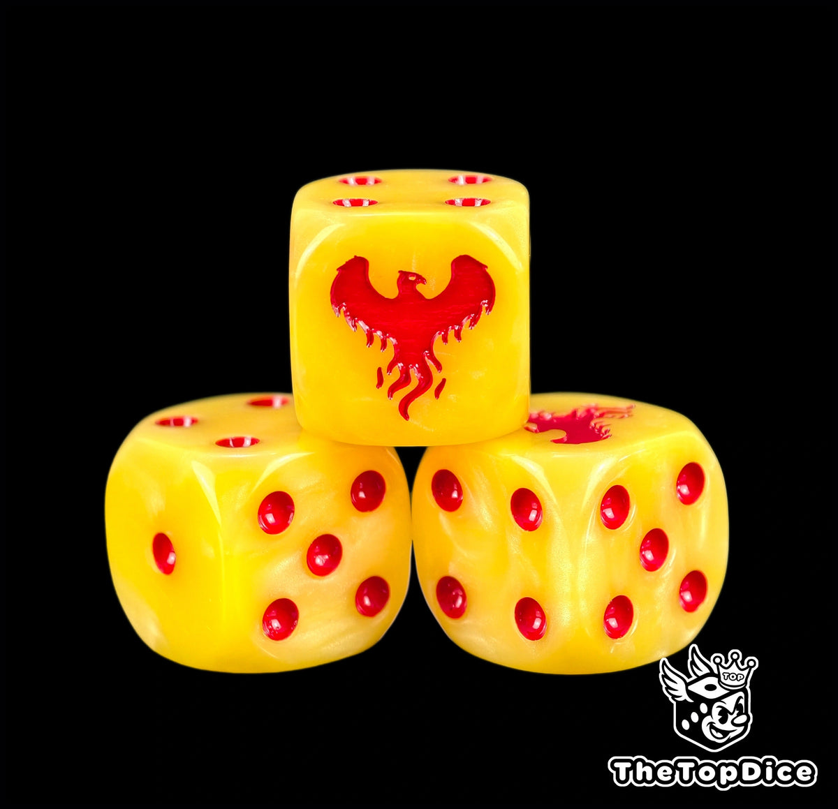 Three yellow Fire Hawks dice with red pips and a red phoenix crest