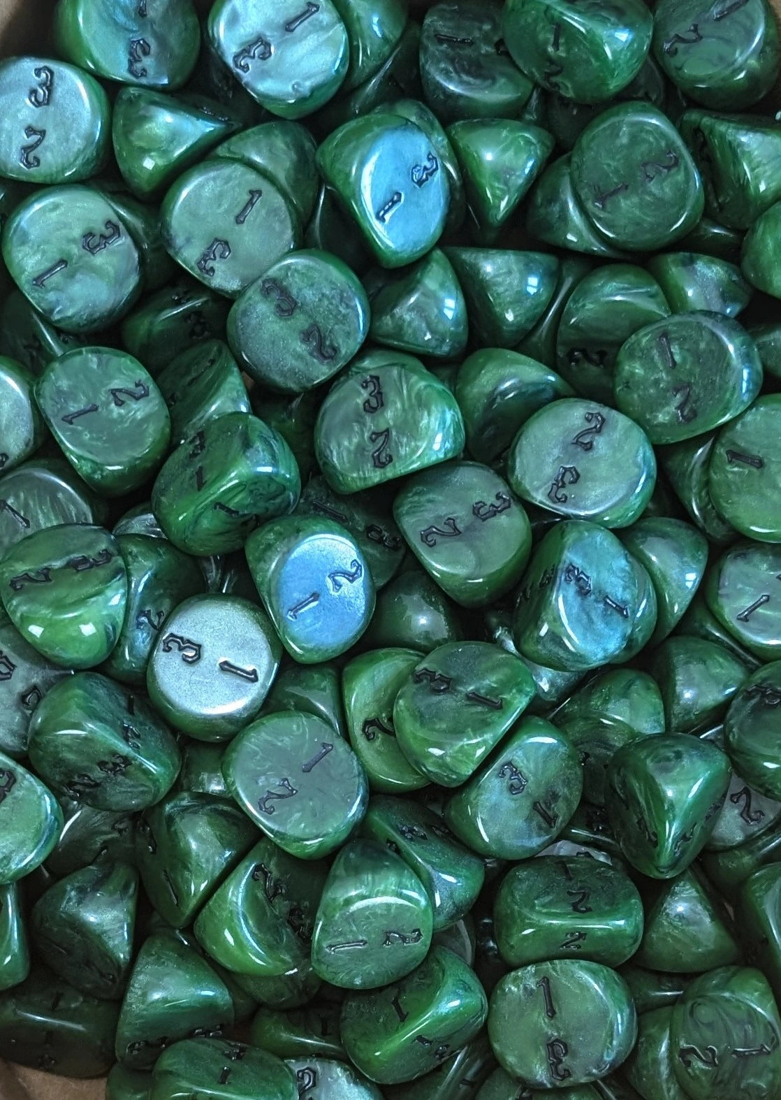 Pile of green D3 three sided dice for tabletop games