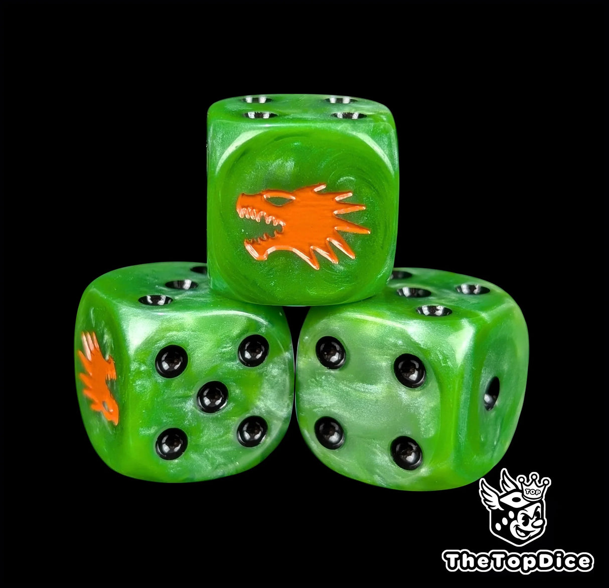 Close up of a green 16mm resin D6 die engraved with an orange drake and black pips