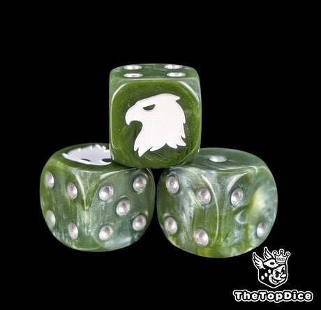 Close up of a green 16mm resin D6 die engraved with a white eagle and silver pips