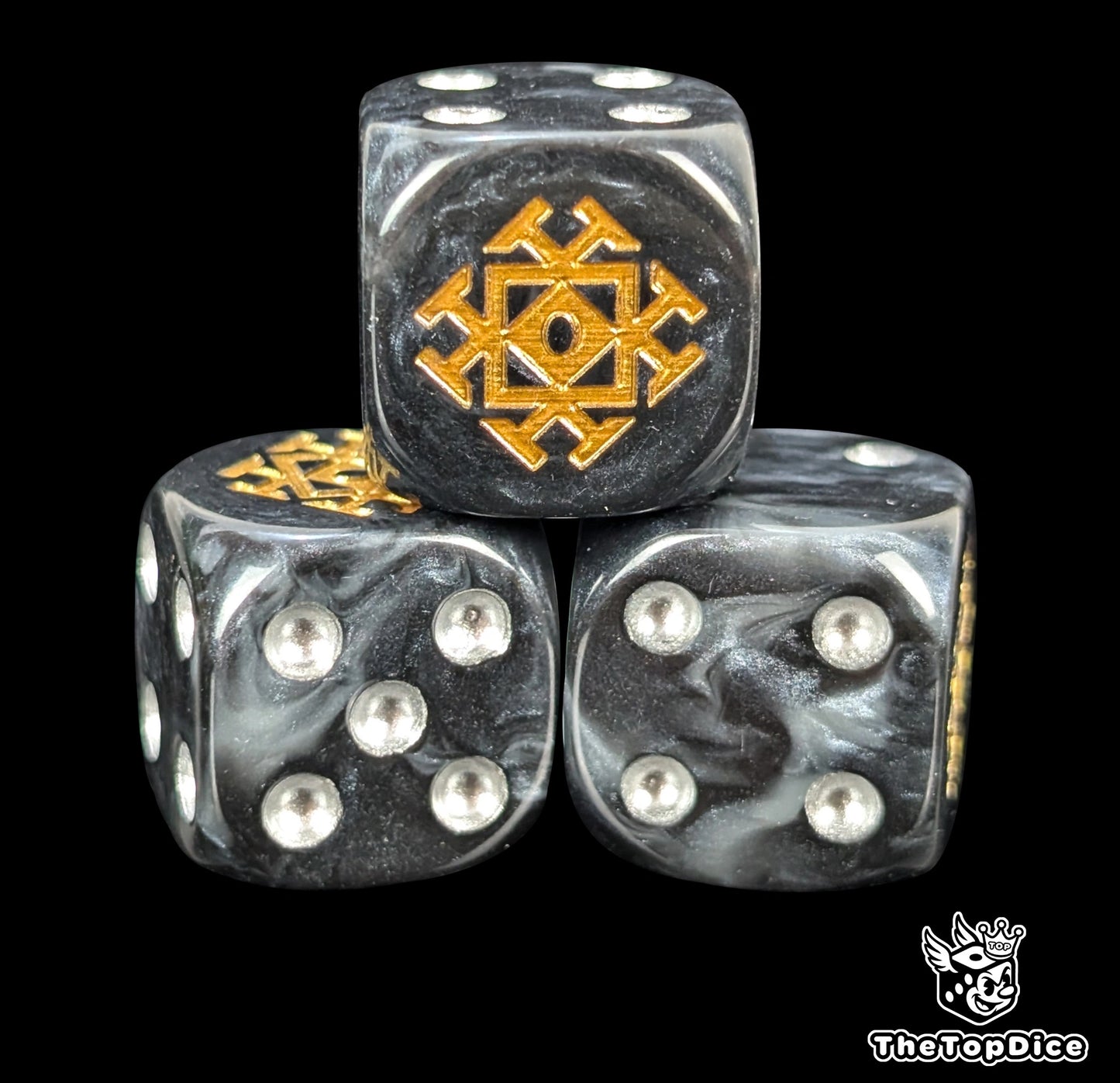 Close up of a grey and black 16mm resin D6 die engraved with a gold throne rune and silver pips
