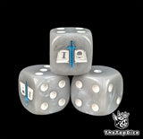 Close-up of a grey D6 die with a white tome pierced by a blue sword