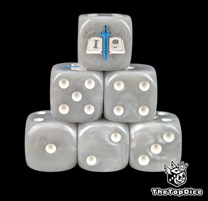 Grey resin D6 dice with a white tome and blue sword emblem and white pips
