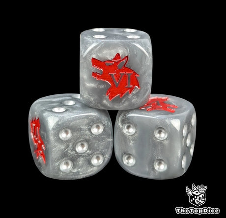 Close up of a grey 16mm resin D6 die engraved with a red wolf and silver pips