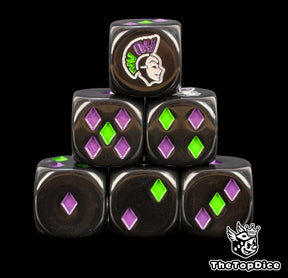 Harlequin D6 dice with green and violet two tone diamond pips on black resin and a pale jester mask