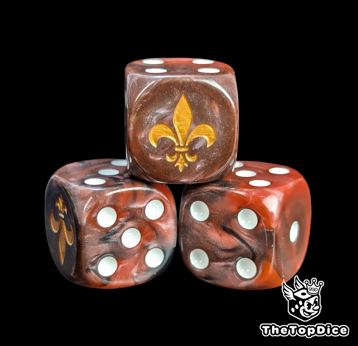 Close-up of a red D6 die with a gold lily emblem