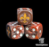 Close-up of a red D6 die with a gold lily emblem