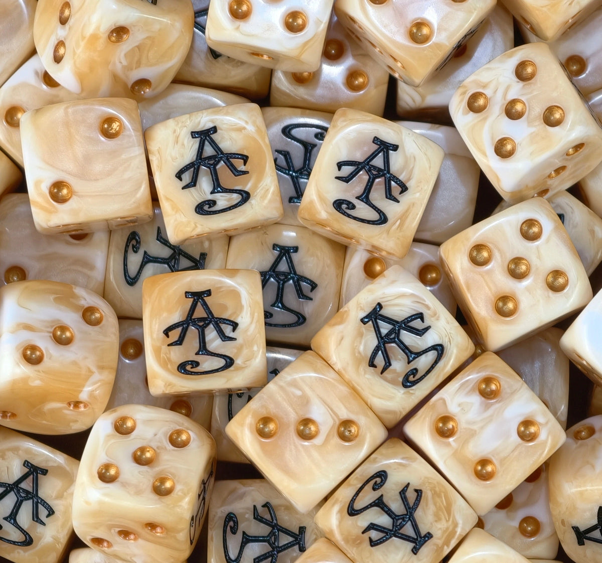 A pile of ivory high elf dice, black runes and gold pips repeating