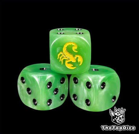 Close up of a green 16mm resin D6 die engraved with a yellow scorpion and black pips