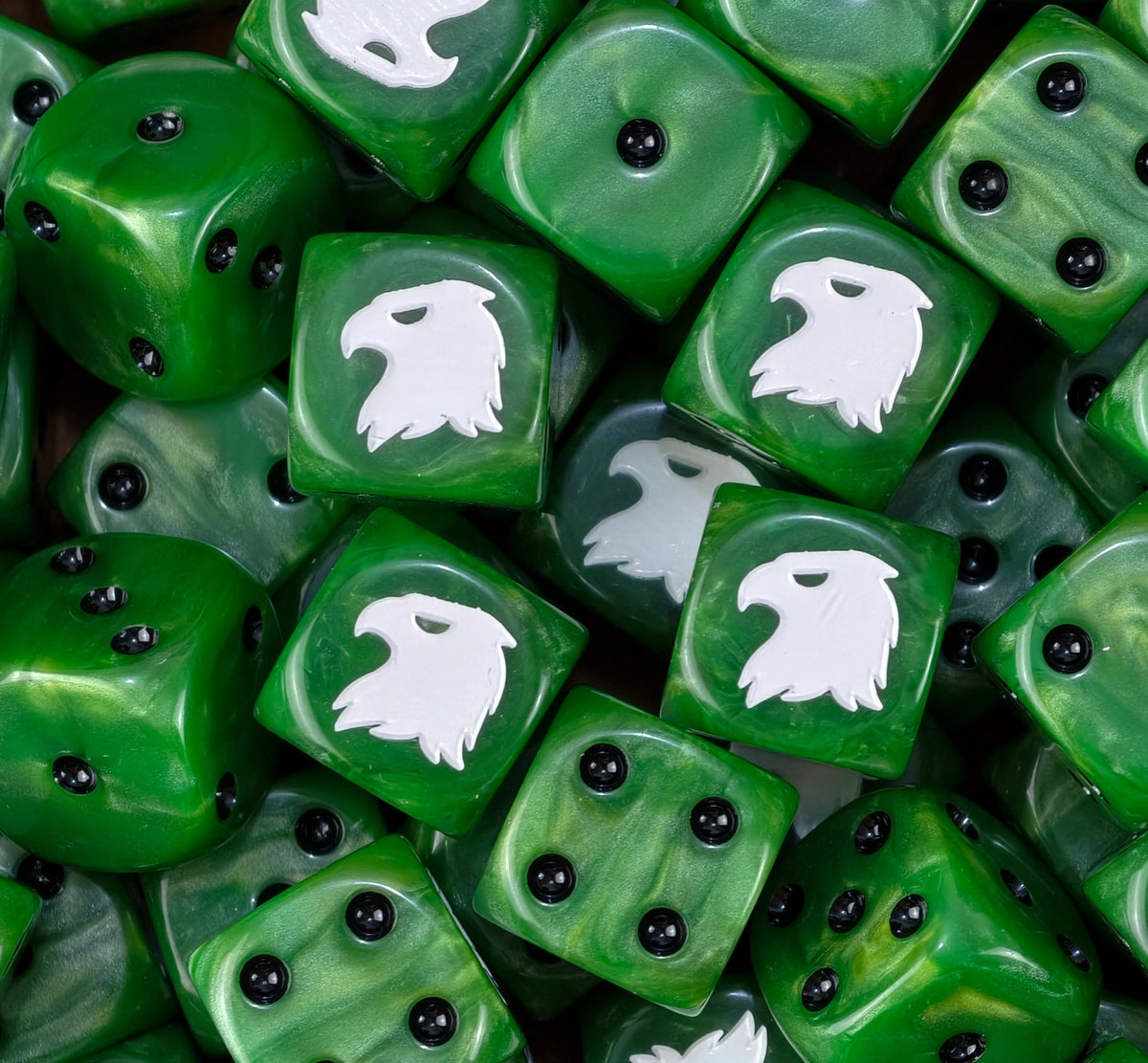 A pile of green Raptors dice, white eagle heads and black pips repeating