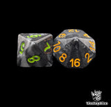 Close up of a black goblin D8 and D16 with green numbers for scatter and long range rolls