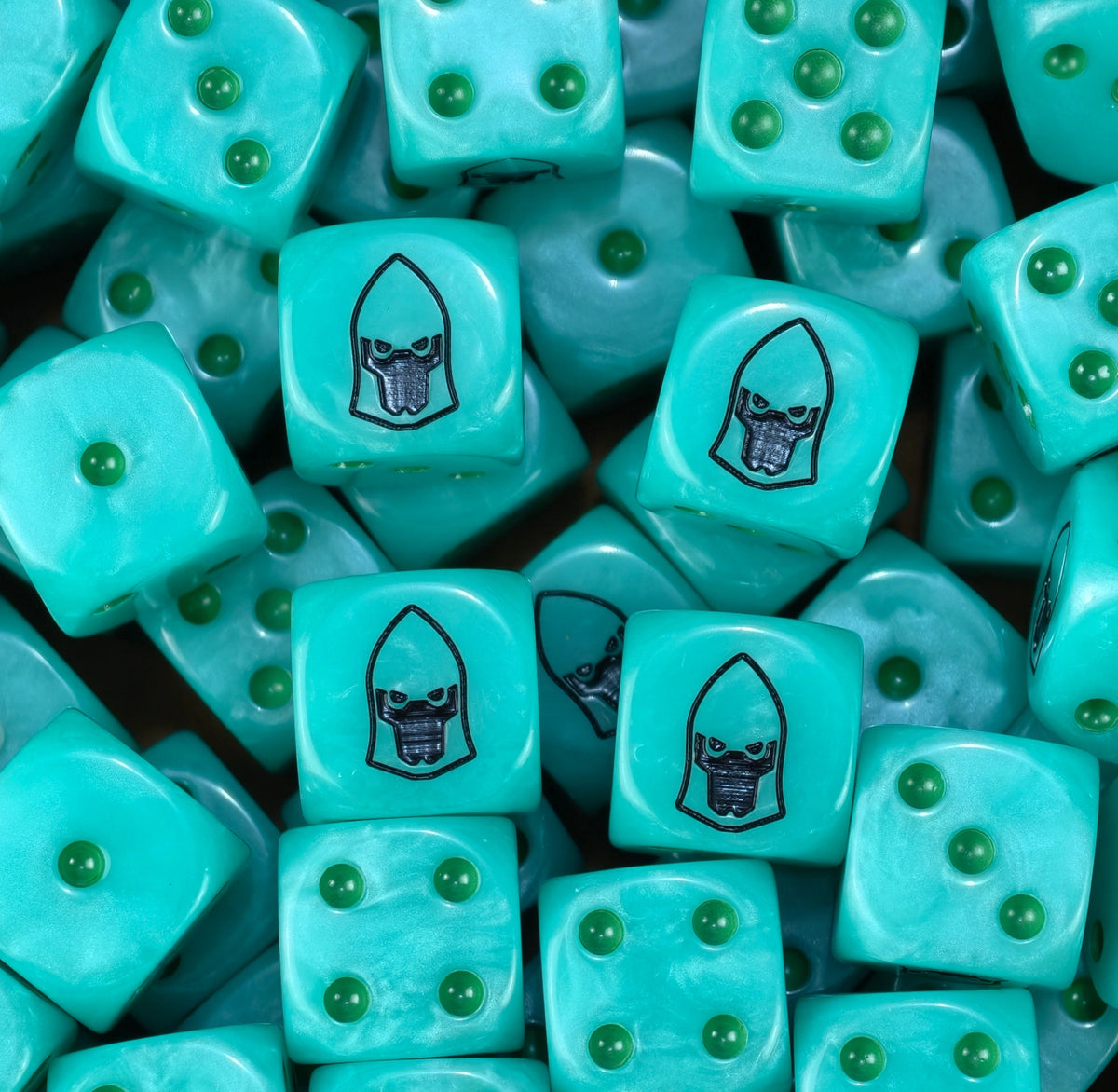 Pile of turquoise Mymeara craftworld eldar dice showing green pips and the black helm face