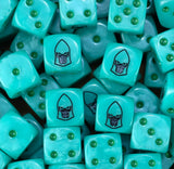 Pile of turquoise Mymeara craftworld eldar dice showing green pips and the black helm face