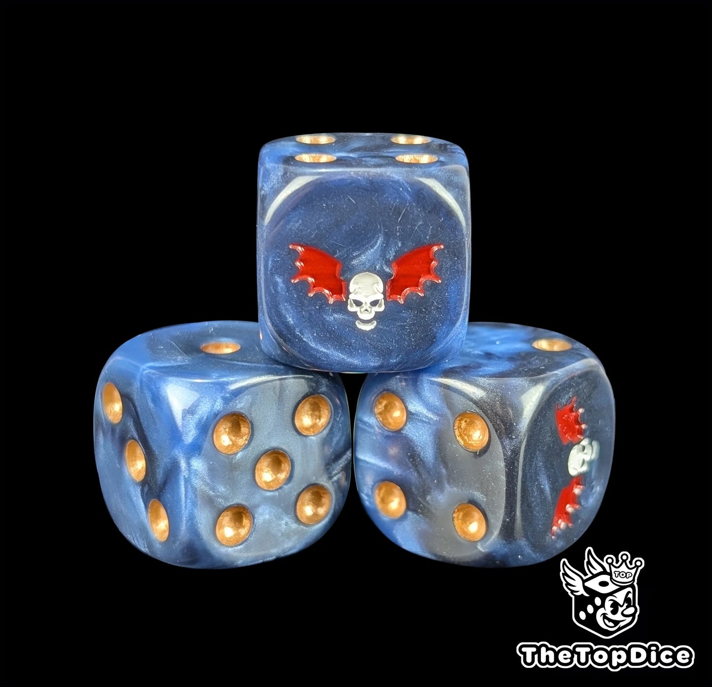Close-up of a dark D6 die with a white skull and two red wings