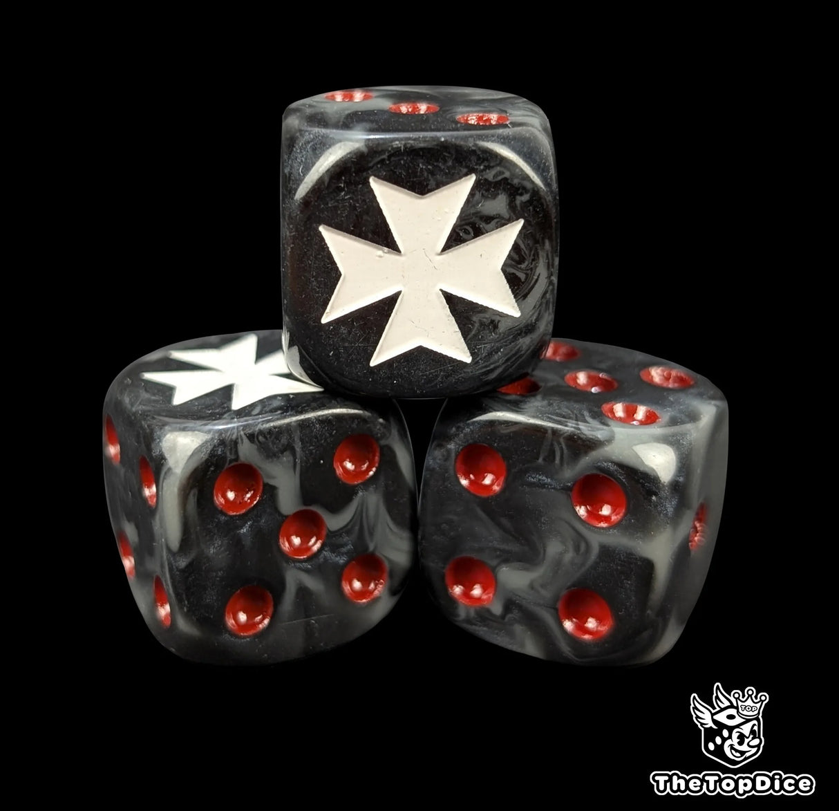 Close up of a black 16mm resin D6 die engraved with a white crusader cross and red pips