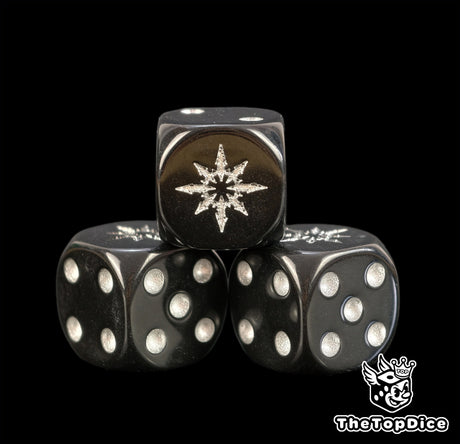 Close up of three black Chaos Space Marines dice with a silver eight pointed star and silver pips