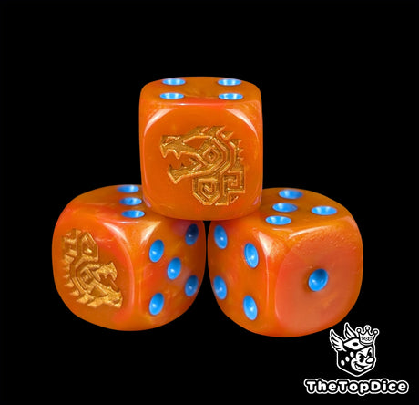 Close up of an orange 16mm resin D6 die engraved with a gold aztec dinosaur rune and blue pips