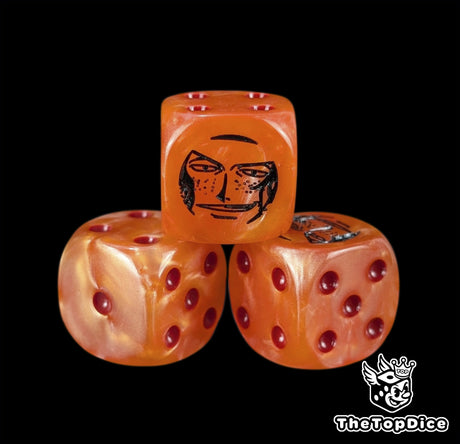 Close up of an orange 16mm resin D6 die engraved with a black pirate emblem and red pips