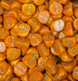 Pile of orange D3 three sided dice for tabletop games