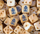 A pile of peach high elf dice, blue runes and gold pips repeating